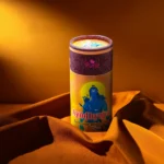 Special Ayoddhyapati Dhoop Canister with Lord Ganesha art, ideal for spiritual home décor, displayed on orange fabric background. – Devsamagri devotional product